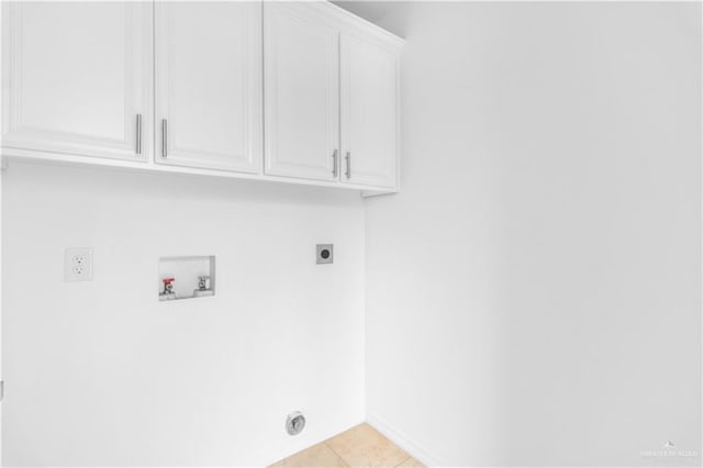 washroom featuring baseboards, hookup for an electric dryer, cabinet space, light tile patterned floors, and washer hookup