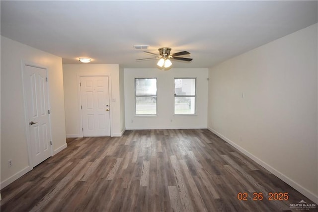 interior space featuring visible vents, baseboards, dark wood-type flooring, and ceiling fan