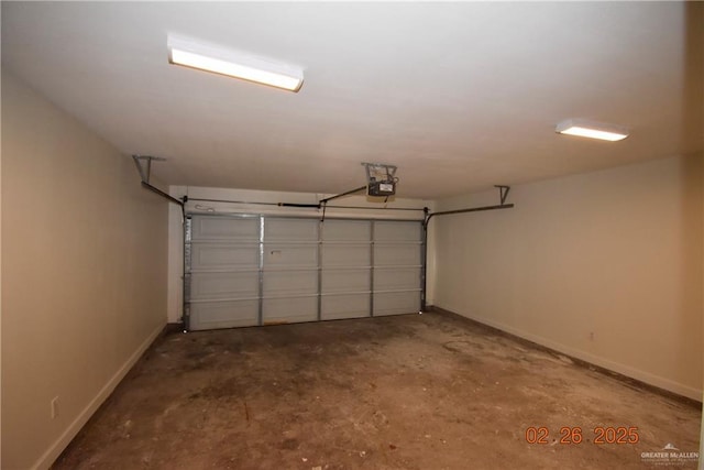 garage featuring baseboards and a garage door opener