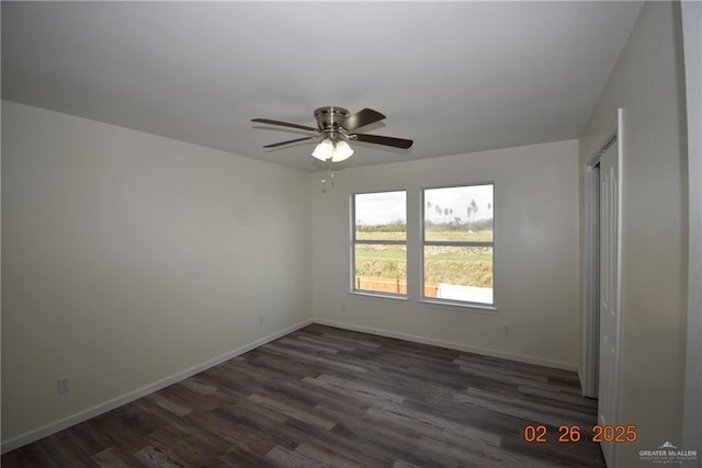 empty room with baseboards, dark wood-style floors, and a ceiling fan