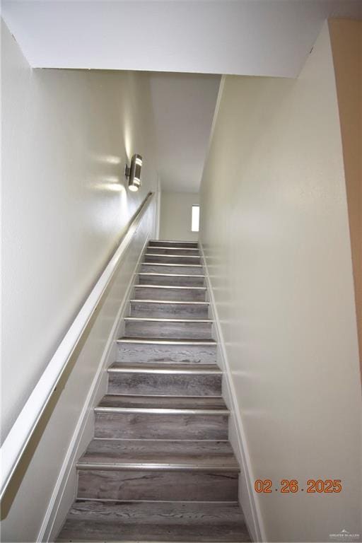 staircase featuring wood finished floors