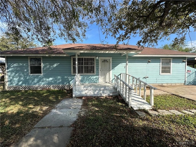 ranch-style house with covered porch and a front lawn