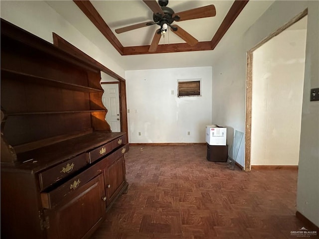 hall with dark parquet flooring and a raised ceiling