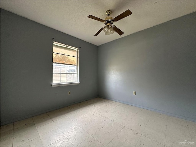 unfurnished room featuring ceiling fan and a textured ceiling