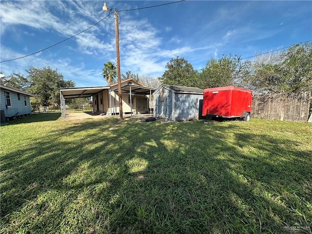 view of yard featuring a carport and a shed