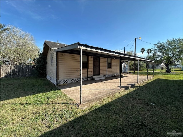 view of side of home with a patio area and a lawn