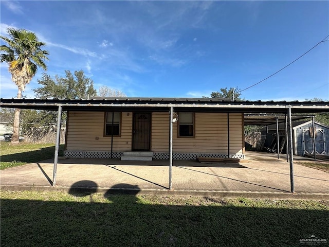 exterior space featuring a carport and a lawn