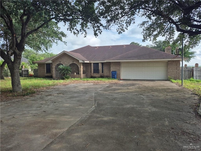 4401 W Monte Cristo Rd, Edinburg, TX 78541 - single story home with driveway, an attached garage, a chimney, and brick siding
