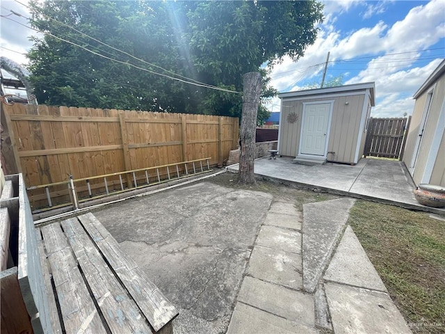 207 W Clark Ave, Pharr, TX 78577 - view of patio / terrace featuring an outdoor structure, a shed, and a fenced backyard
