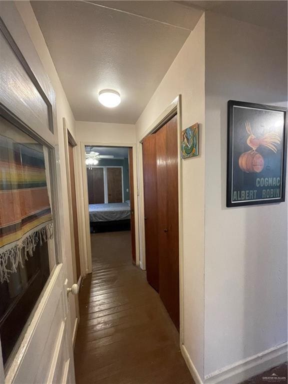 207 W Clark Ave, Pharr, TX 78577 - hall featuring dark wood-style flooring and baseboards