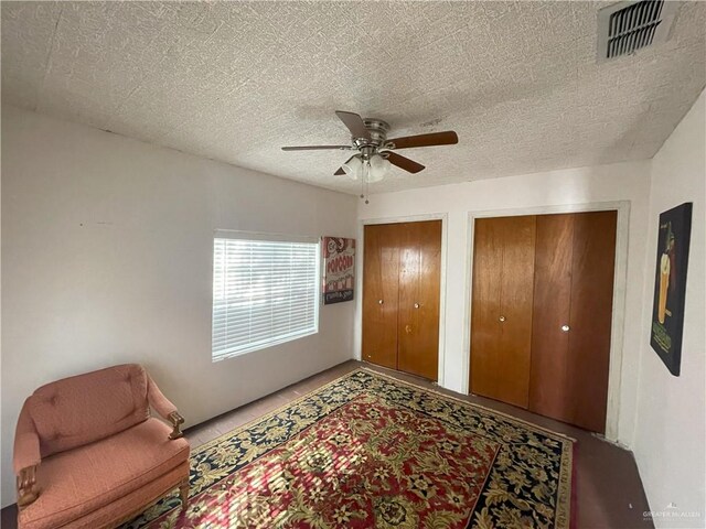 207 W Clark Ave, Pharr, TX 78577 - living area featuring visible vents, ceiling fan, and a textured ceiling