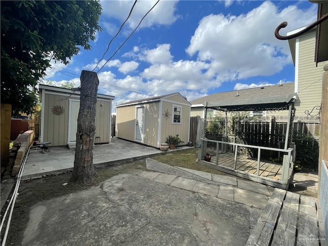 207 W Clark Ave, Pharr, TX 78577 - view of patio featuring a deck, a storage unit, a fenced backyard, and an outdoor structure