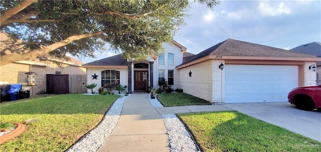 view of front of home with a front lawn and a garage