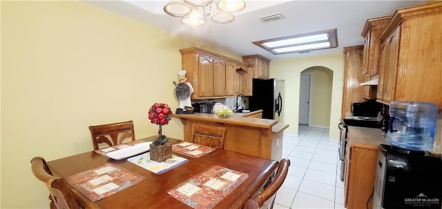 dining room with light tile patterned floors and sink