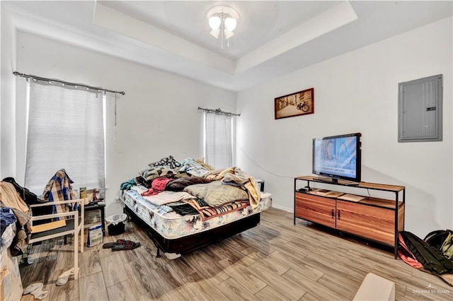 406 S 21st St, Mcallen, TX 78501 - bedroom with electric panel, a raised ceiling, light wood-style floors, and baseboards
