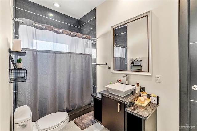 bathroom with shower / bath combination with curtain, tile patterned flooring, vanity, and toilet