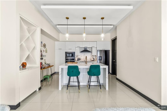 kitchen with white cabinets, light countertops, built in microwave, modern cabinets, and decorative light fixtures