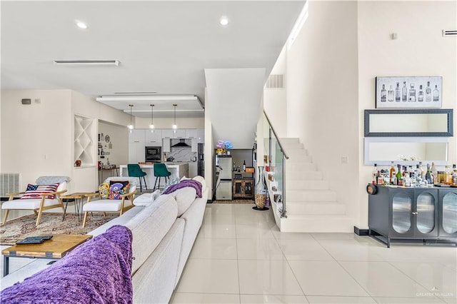 living area featuring recessed lighting, visible vents, stairway, and light tile patterned flooring