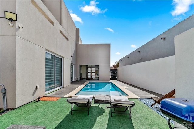 view of pool featuring a yard, area for grilling, and a fenced in pool