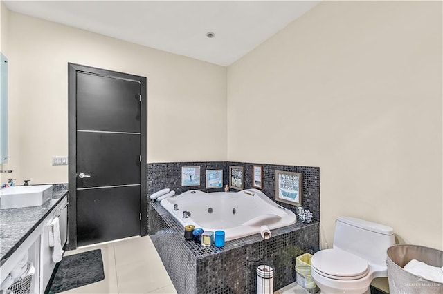 bathroom with toilet, tile patterned floors, a tub with jets, and vanity