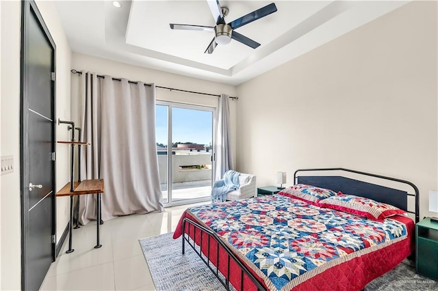 bedroom featuring access to outside, a raised ceiling, a ceiling fan, and light tile patterned flooring