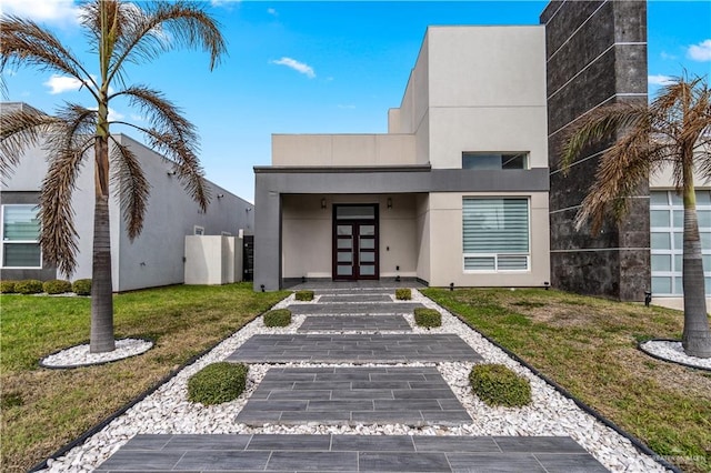 view of front of property with a front yard and stucco siding