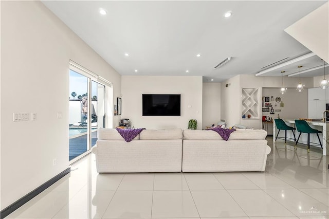 living room featuring light tile patterned floors and recessed lighting