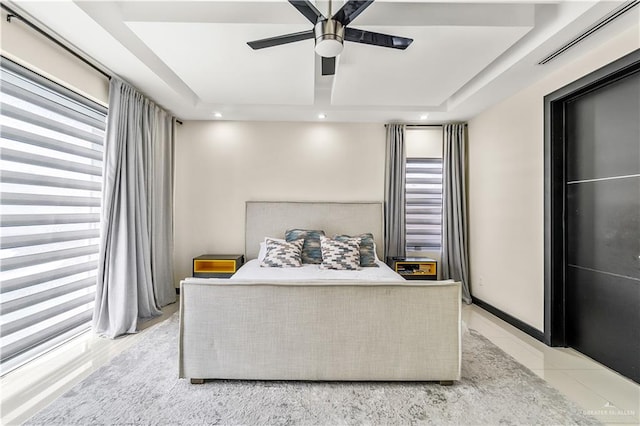 bedroom featuring ceiling fan, recessed lighting, visible vents, baseboards, and a tray ceiling