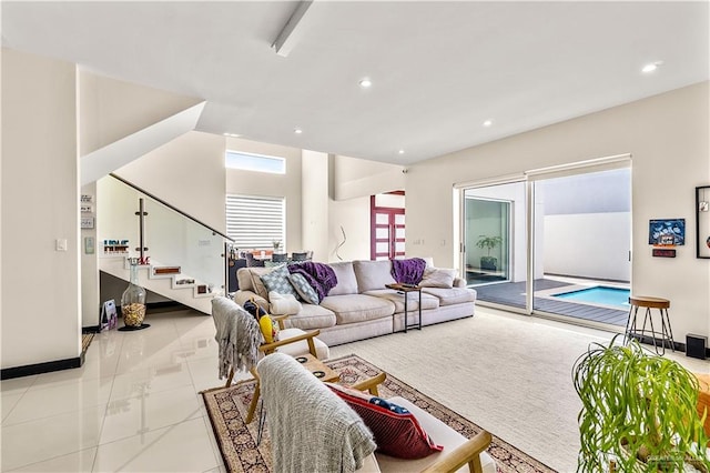 living area with light tile patterned flooring, baseboards, stairway, and recessed lighting