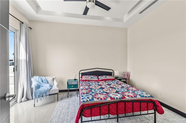 bedroom with light tile patterned floors, a raised ceiling, visible vents, ceiling fan, and baseboards