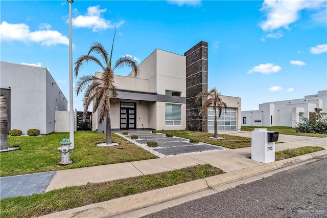 view of property with an attached garage, a residential view, and concrete driveway