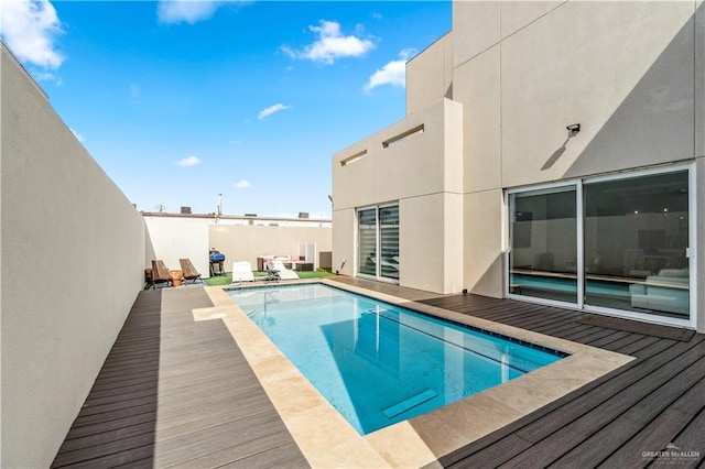 view of swimming pool with a fenced in pool