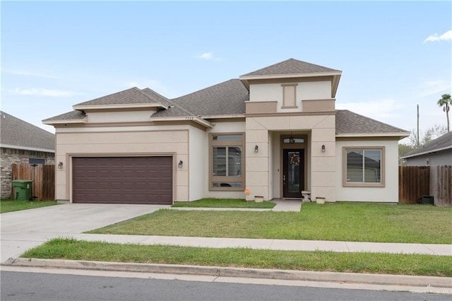 view of front of property with a garage and a front lawn