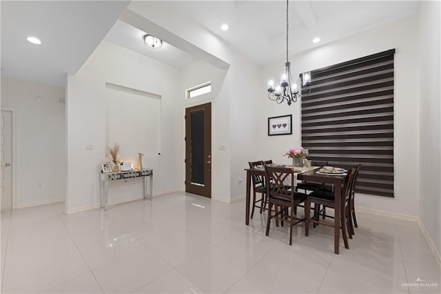 tiled dining space featuring an inviting chandelier