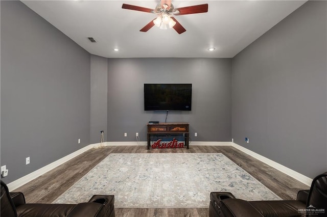 living room with hardwood / wood-style floors and ceiling fan