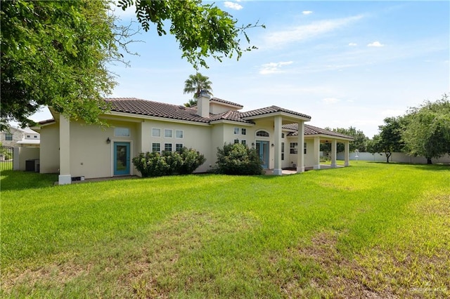 back of property featuring a lawn and central AC unit