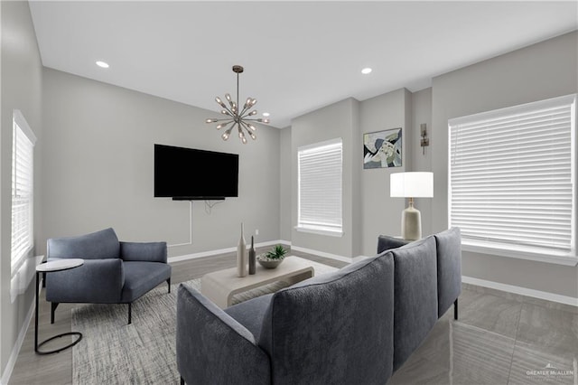 living area featuring a chandelier, recessed lighting, and baseboards