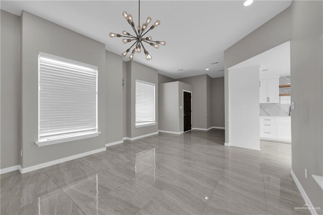 interior space featuring baseboards, recessed lighting, and a notable chandelier