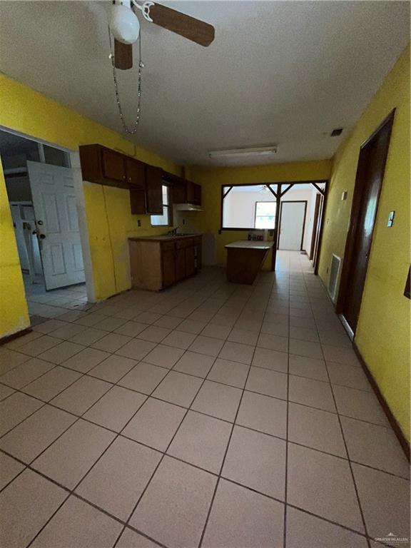 2322 E La Pointe Ave, Alton, TX 78573 - kitchen with light tile patterned floors, a ceiling fan, and open floor plan