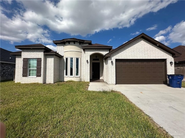 view of front of home with a garage and a front lawn