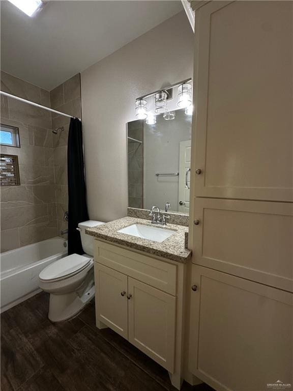 full bathroom with shower / bath combination with curtain, vanity, wood-type flooring, and toilet