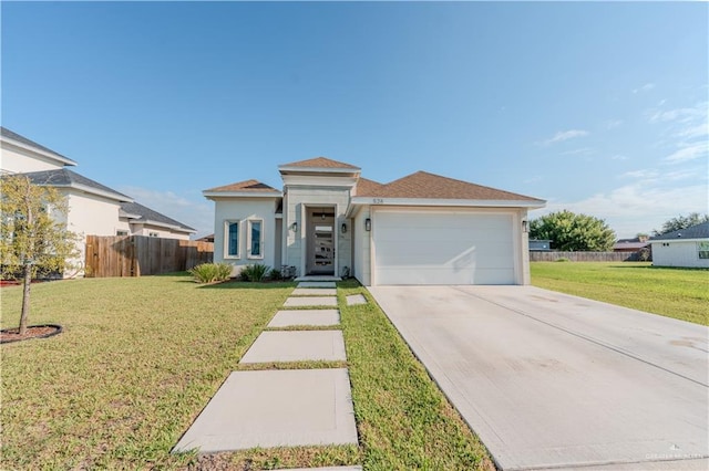 view of front of house with a garage and a front lawn