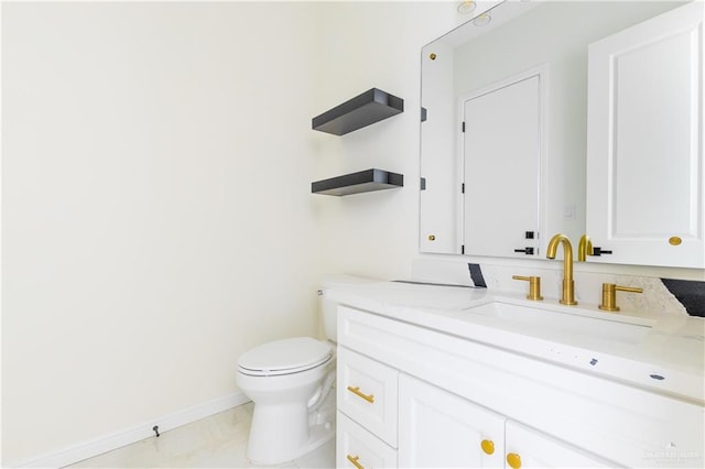 bathroom with tile patterned flooring, vanity, and toilet