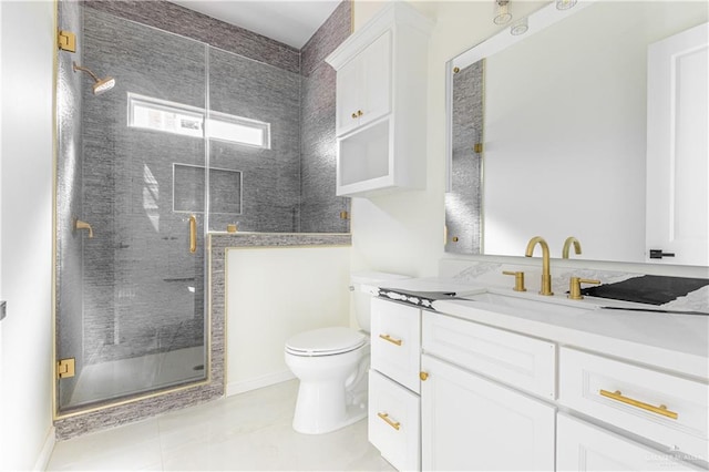 bathroom featuring tile patterned flooring, vanity, toilet, and an enclosed shower