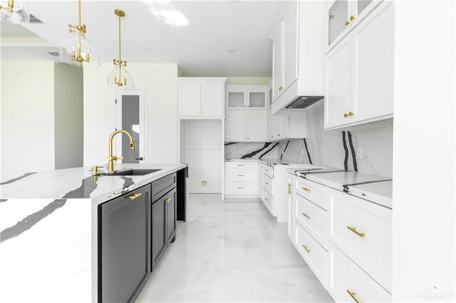 kitchen featuring a notable chandelier, decorative light fixtures, white cabinetry, and sink