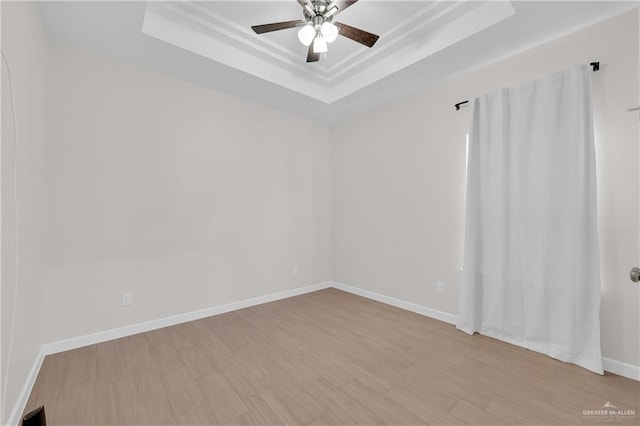 9219 N 25th St, Mcallen, TX 78504 - unfurnished room featuring light wood-style flooring, baseboards, a raised ceiling, and a ceiling fan