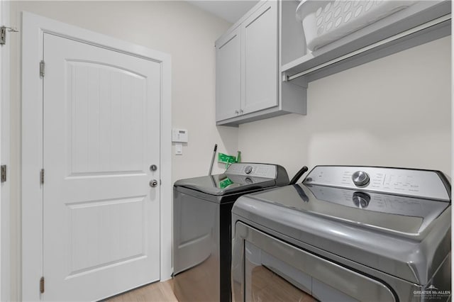 9219 N 25th St, Mcallen, TX 78504 - laundry area with light wood-type flooring, cabinet space, and washer and dryer