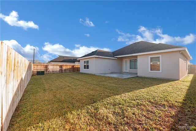 9219 N 25th St, Mcallen, TX 78504 - back of house featuring a yard, a fenced backyard, stucco siding, and a patio