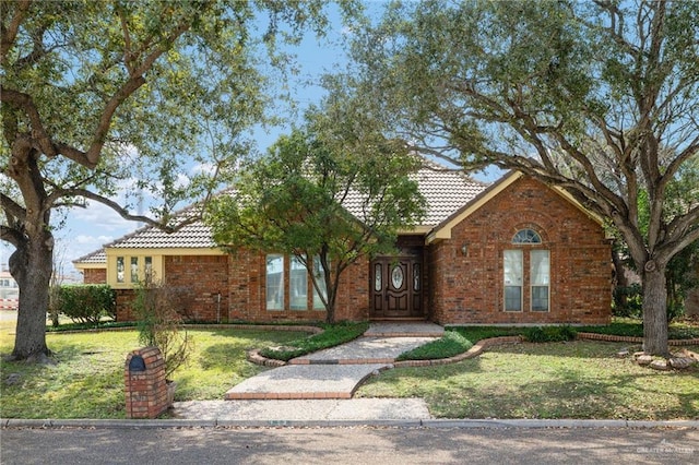 ranch-style home with a front lawn