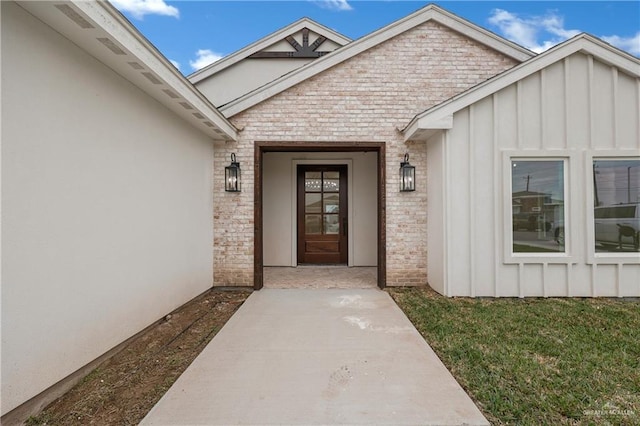 entrance to property featuring a lawn